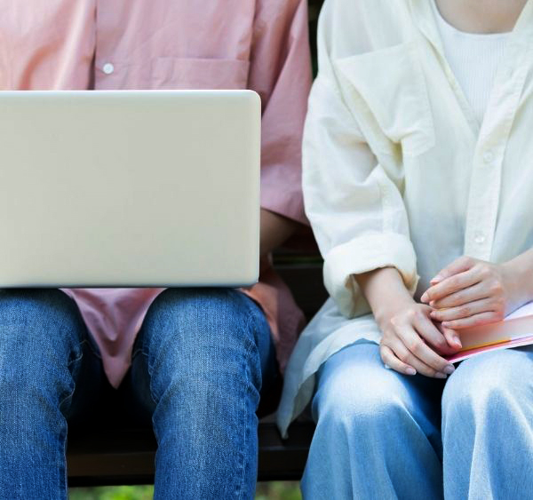 Close up of a couple with a laptop on the mans lap