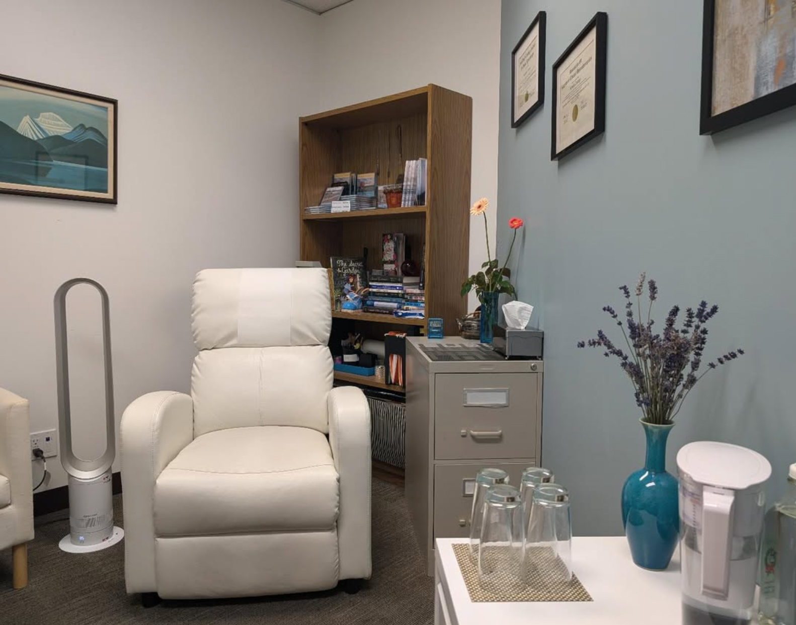 Counselling office with a white lounge chair and a blue accent wall